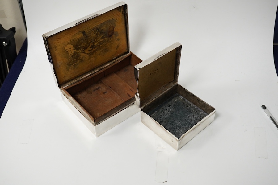 Two silver engraved cigarette boxes (a.f.). largest 16.6cm. Condition - poor